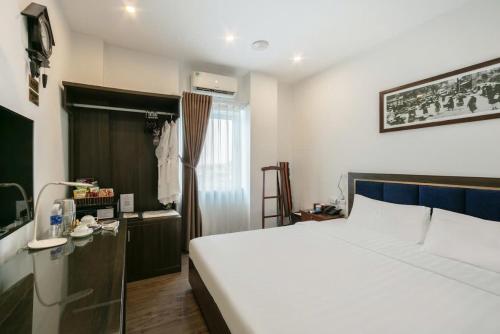 a bedroom with a large white bed and a window at A25 Hotel - 30 An Dương in Hanoi