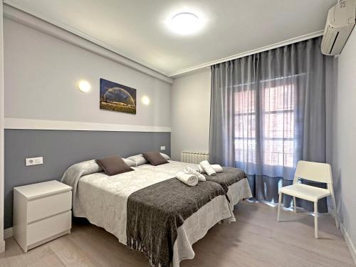 a bedroom with a large bed and a window at Apartamento Turístico VIANA I in Viana