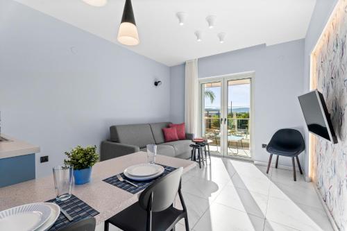 a living room with a table and chairs and a couch at Frunze Luxury Apartments in Nafplio