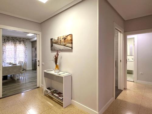 a living room with a vase on a table at Apartamento Turístico VIANA II in Viana