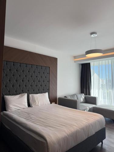 a bedroom with a large bed and a couch at Grand sapphire resort Ötüken yeni iskele North Cyprus in İskele