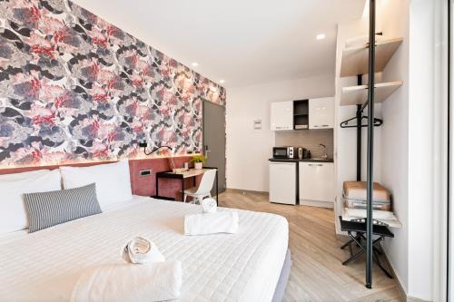 a bedroom with a large bed with a floral wall at Frunze Luxury Apartments in Nafplio
