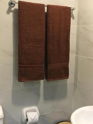 two brown towels hanging on a wall in a bathroom at Cityscape Grand Tower Cebu - 2 Bedrooms with Balcony Close to Ayala Mall - New Condo in Cebu City
