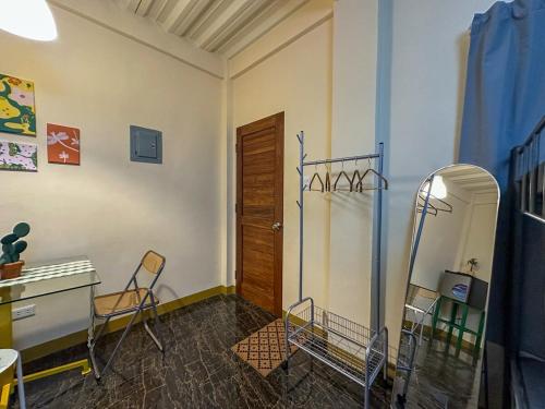 a room with chairs and a desk and a mirror at Stylish Studio Near Kabsat Surf Spots Urbiztondo San Juan LU in San Juan
