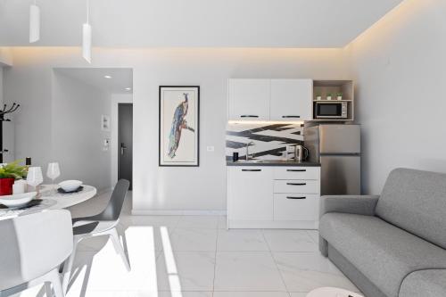a kitchen and living room with a couch and a table at Frunze Luxury Apartments in Nafplio