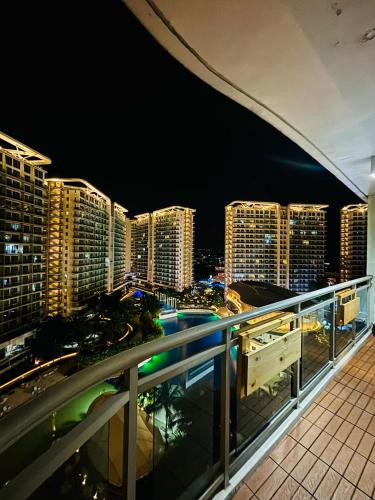 a view of a city at night from a balcony at Holiday Escape Philippines in Manila