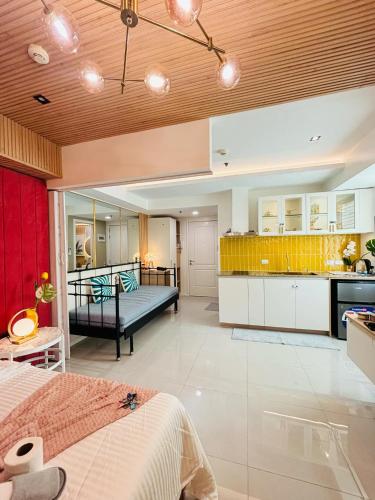 a large room with a bed and a kitchen at Holiday Escape Philippines in Manila