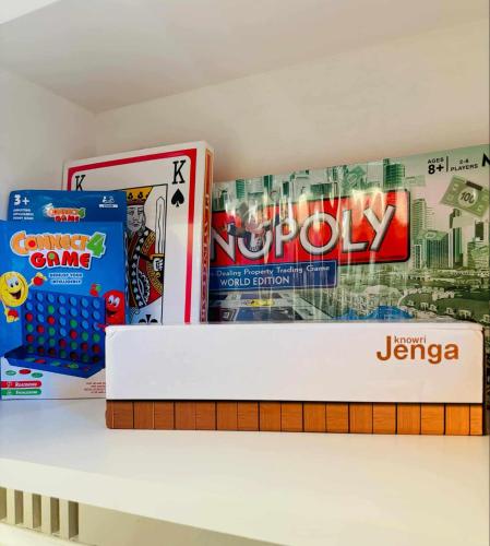 a shelf filled with games and board games at Holiday Escape Philippines in Manila