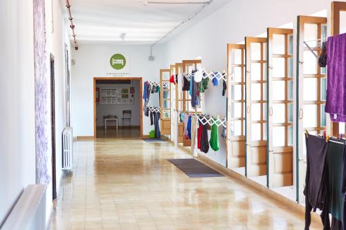 a store hallway with racks of clothes on display at Albergue Seminario Menor in Santiago de Compostela