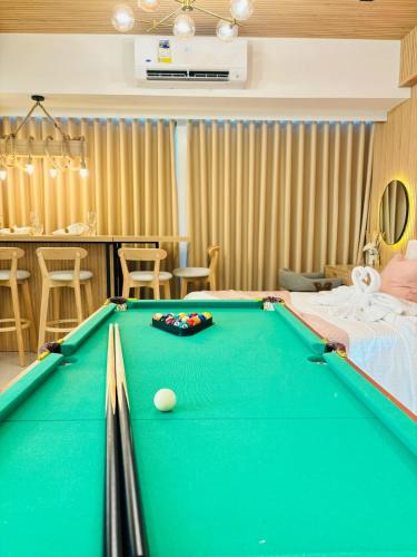 a living room with a pool table in a room at Holiday Escape Philippines in Manila