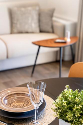 a table with a plate and a glass on it at Frunze Luxury Apartments in Nafplio
