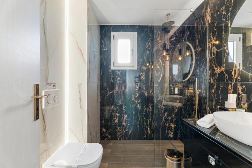 a bathroom with a toilet and a sink at Frunze Luxury Apartments in Nafplio