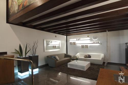 a living room with a couch and a table at Hotel Castilla Vieja in Palencia