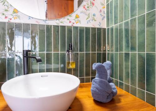a bathroom with a sink and a tiled wall at Hotel Krone Tirol in Reutte