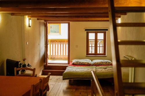a bedroom with a bed in a room with a window at Apartment Bernarda - Entire House in Kobarid