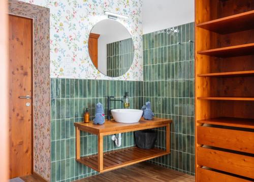 a bathroom with a sink and a mirror at Hotel Krone Tirol in Reutte