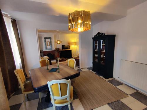 a dining room with a wooden table and chairs at Gîte en Sologne in Vouzon