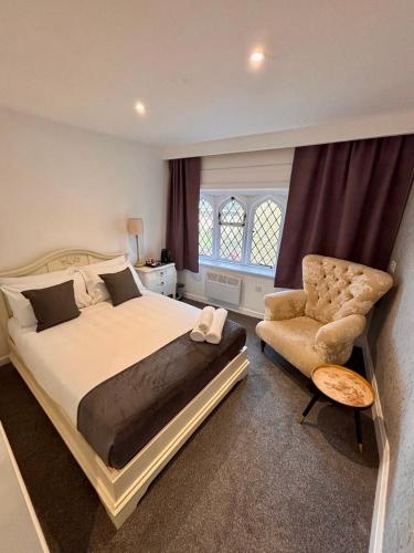 a bedroom with a large bed and a chair at Juniper Berry in Southampton