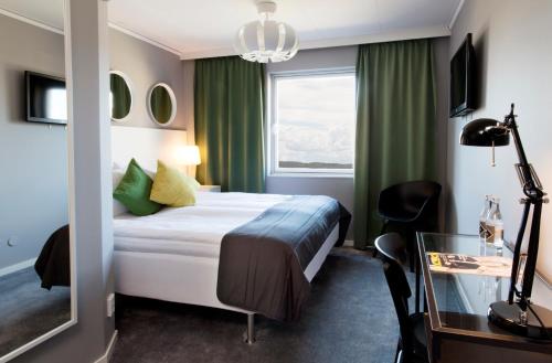 a hotel room with a bed and a window at Welcome Hotel Barkarby in Järfälla