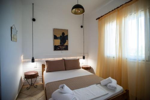 a bedroom with a bed with towels on it at Mare nostrum - Alykes Zakynthou in Alykes