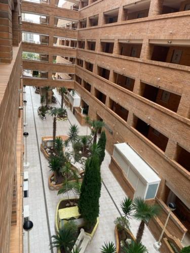 an overhead view of a building with palm trees in a courtyard at Torremar - Magic World - Marina d'or in El Borseral
