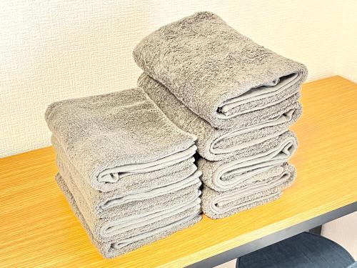 a pile of towels sitting on top of a table at Highness Gojo in Dazaifu