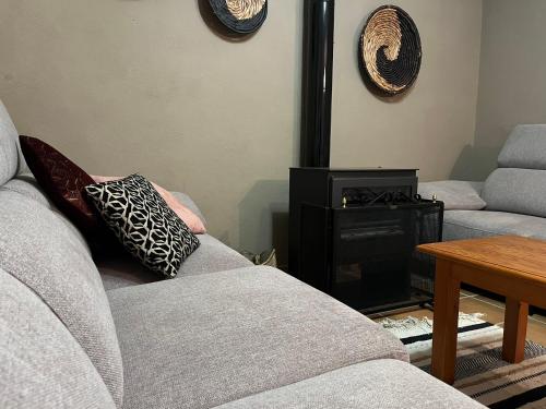 a living room with a couch and a fire place at CASA RURAL MASIA ARINESA Culla in Culla