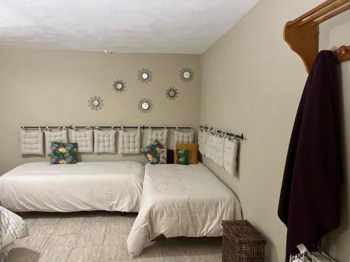 a bedroom with two beds and clocks on the wall at CASA RURAL MASIA ARINESA Culla in Culla