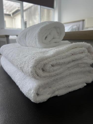 a stack of towels sitting on top of a table at Beechwood Lodges in Ballycastle
