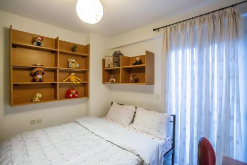 Ένα ή περισσότερα κρεβάτια σε δωμάτιο στο Chris Cozy Apartment
