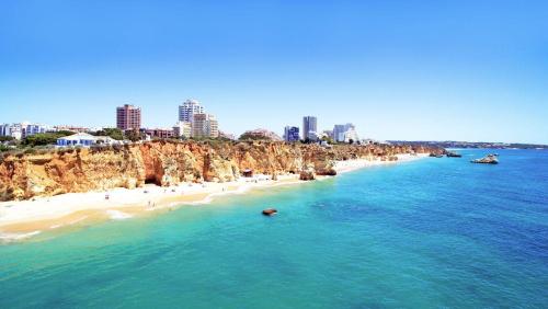 an aerial view of a beach with a city in the background at Portimao Elegant House With Pool by Homing in Portimão