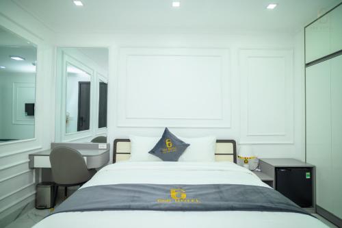 a bedroom with a large bed and a desk at 6668 Hotel - Chi nhánh 1 in Tây Ninh