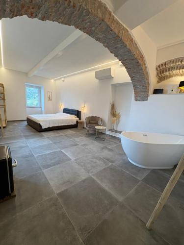 a large room with a bed and a bath tub at The Orange Garden in Corniglia