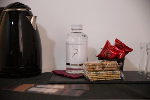 a bottle of water sitting next to a container of crackers at Vicolo delle Belle Suite in Terracina