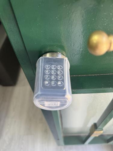 a remote control sitting on top of a green table at A&R Santiago de Compostela in San Sebastián de los Reyes