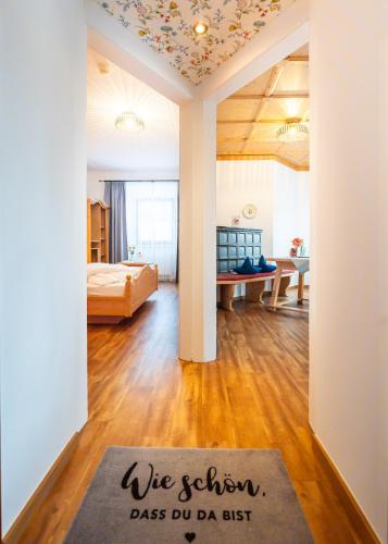 a room with a bed and a rug on the floor at Hotel Krone Tirol in Reutte