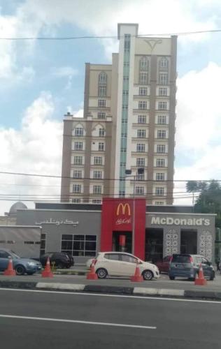 a large building with cars parked in front of it at S2 Studio deviana Wakaf Che Yeh in Kota Bharu