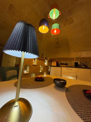 a lamp on top of a table in a kitchen at Vico Luxury Room in Mesagne