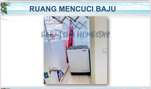 a room with a refrigerator in the middle of a boat at MUTIARA MELAKA BEACH RESORT By Darnisha Homestay in Melaka