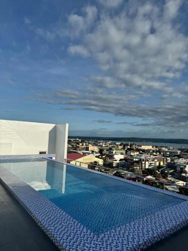 a swimming pool on the roof of a building at Condo 801 Bernwood Tower in Iloilo City