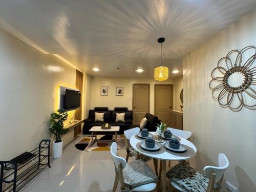 a living room with a table and a couch at Condo 801 Bernwood Tower in Iloilo City