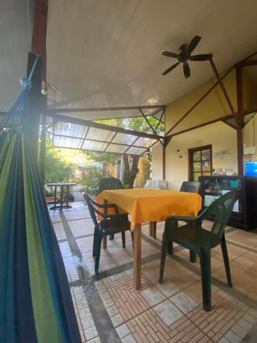 a table and chairs in a patio with a ceiling fan at Cabinas surf Arribadas in Playa Ostional