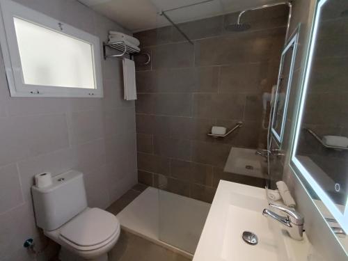 a bathroom with a toilet and a sink and a shower at Mendez Nuñez Alicante in Alicante