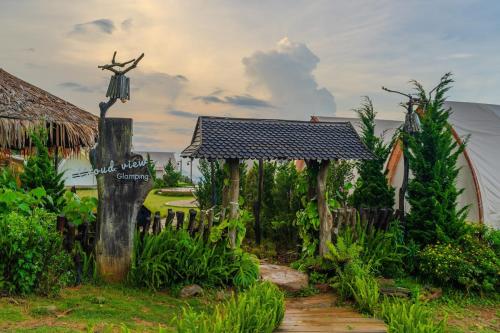 a path leading to a house with a cross on it at Cloud9 & Cloud View Glamping in Da Lat