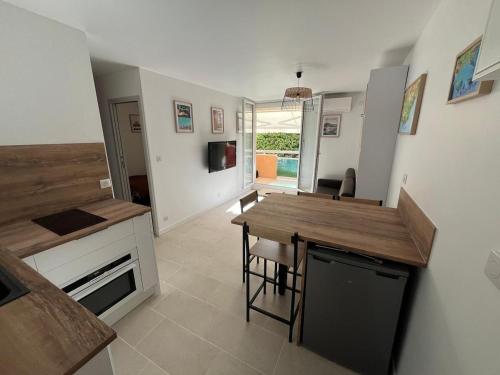 une cuisine avec une table et un comptoir dans l'établissement Très beau T2 4 personnes 200 m plage de la Favière, à Bormes-les-Mimosas