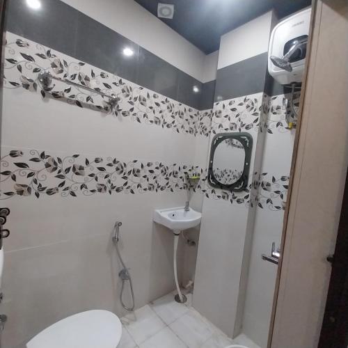 a bathroom with a shower and a sink and a toilet at ViratHomestay in Varanasi