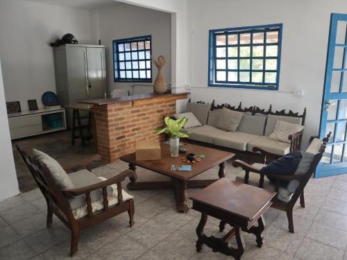 a living room with a couch and a table at Guaecá Hostel - Cumuruxatiba in Cumuruxatiba