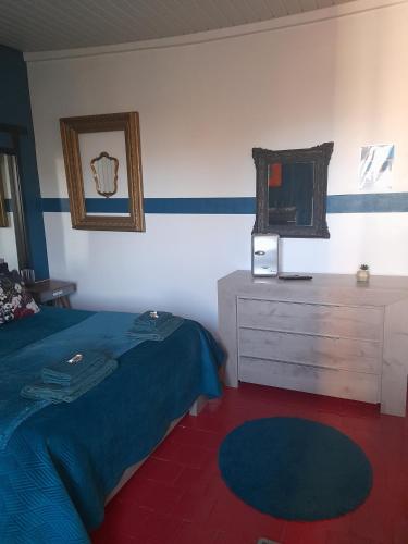 a bedroom with a bed and a dresser and a mirror at Marie-Claire la grillade in Briare
