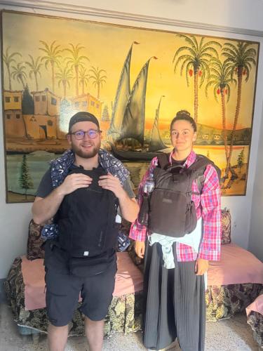 a man and a woman standing in front of a painting at SEO House in Aswan