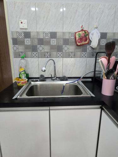 a kitchen with a sink and a counter top at Private pool Cassa Dinies, Wifi , Bbq,10 pax in Rantau Panjang